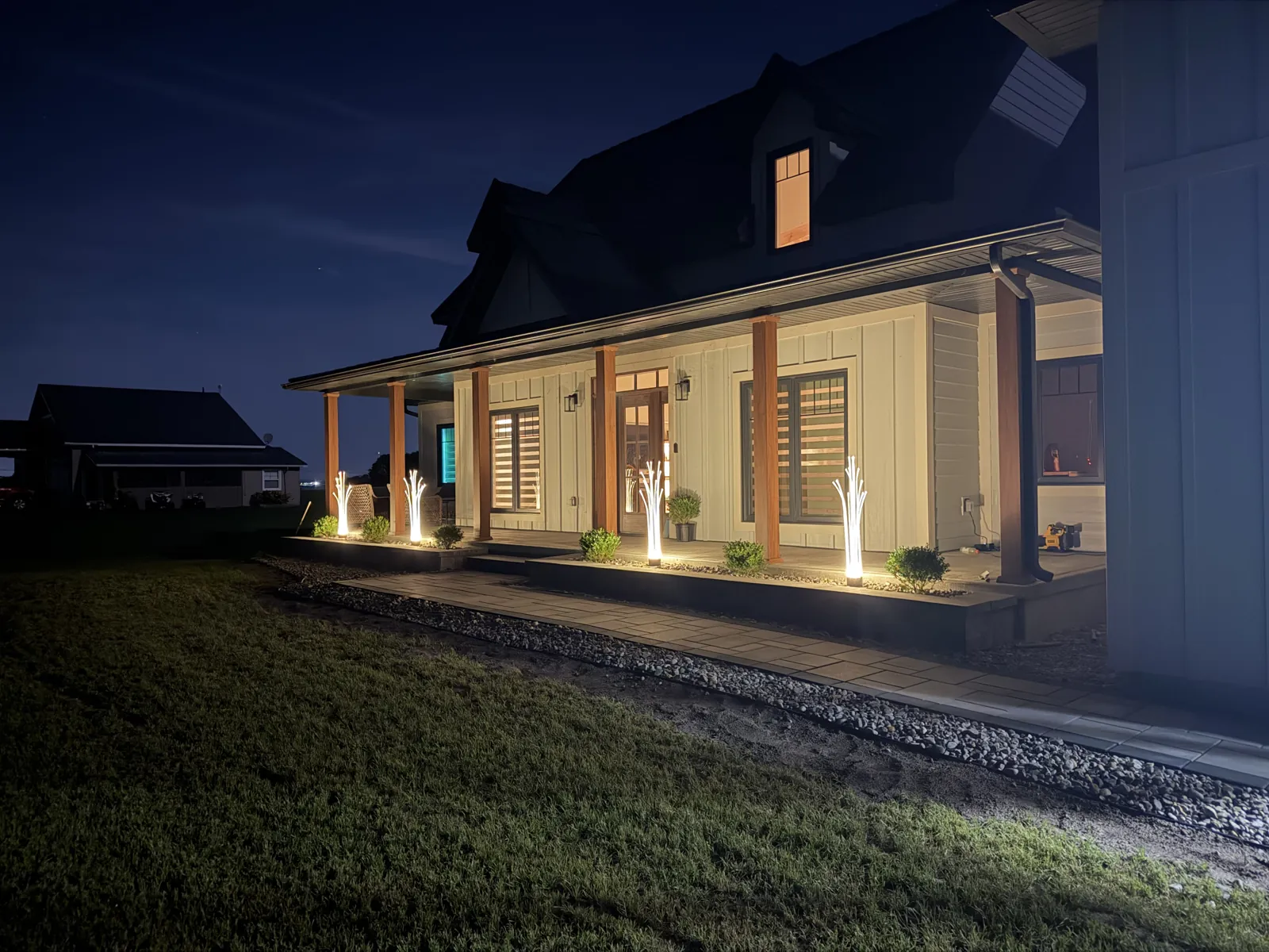 Custom home front porch with lighting at night