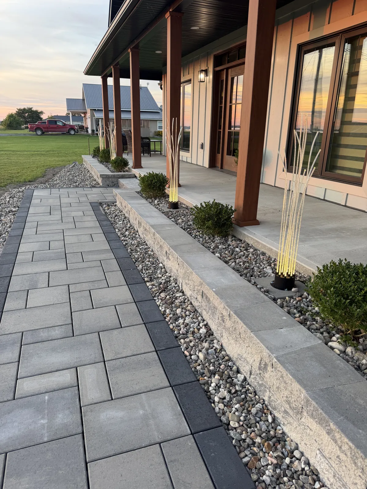 Paver walkway and retaining wall leading to a porch